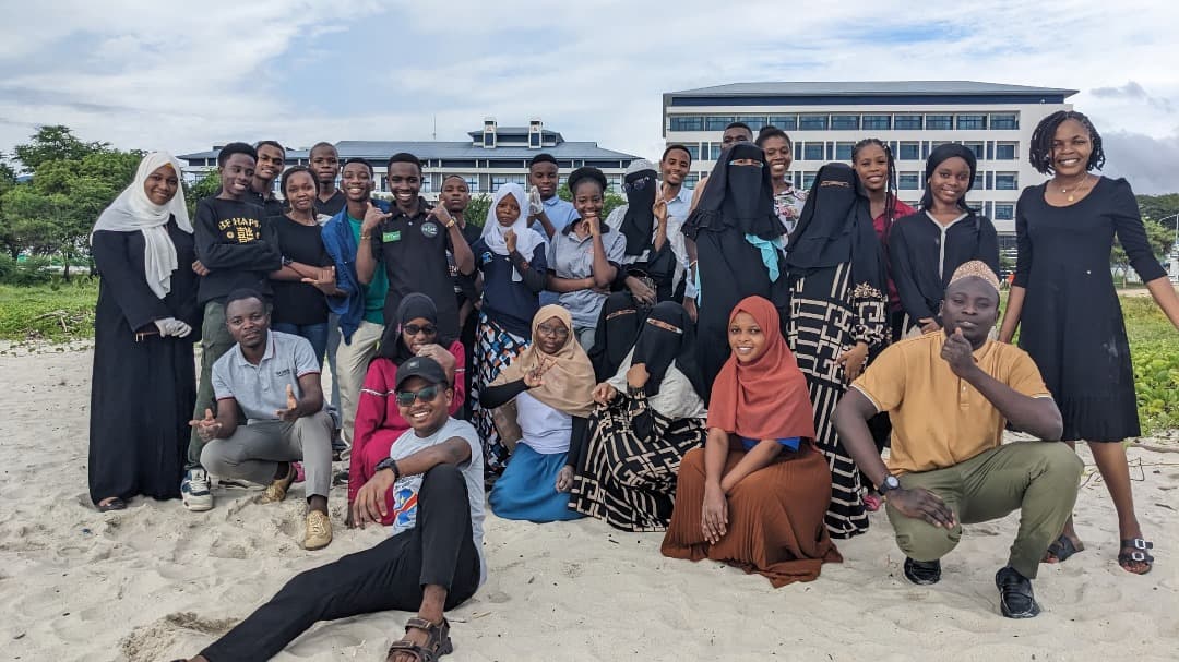 Think Green volunteers gathered on a beach in Dar es Salaam